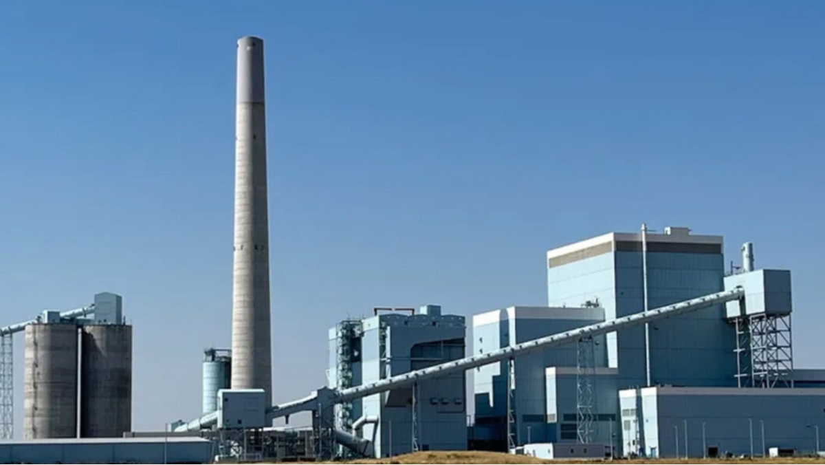 Industrial power plant with tall smokestack and connected facility buildings