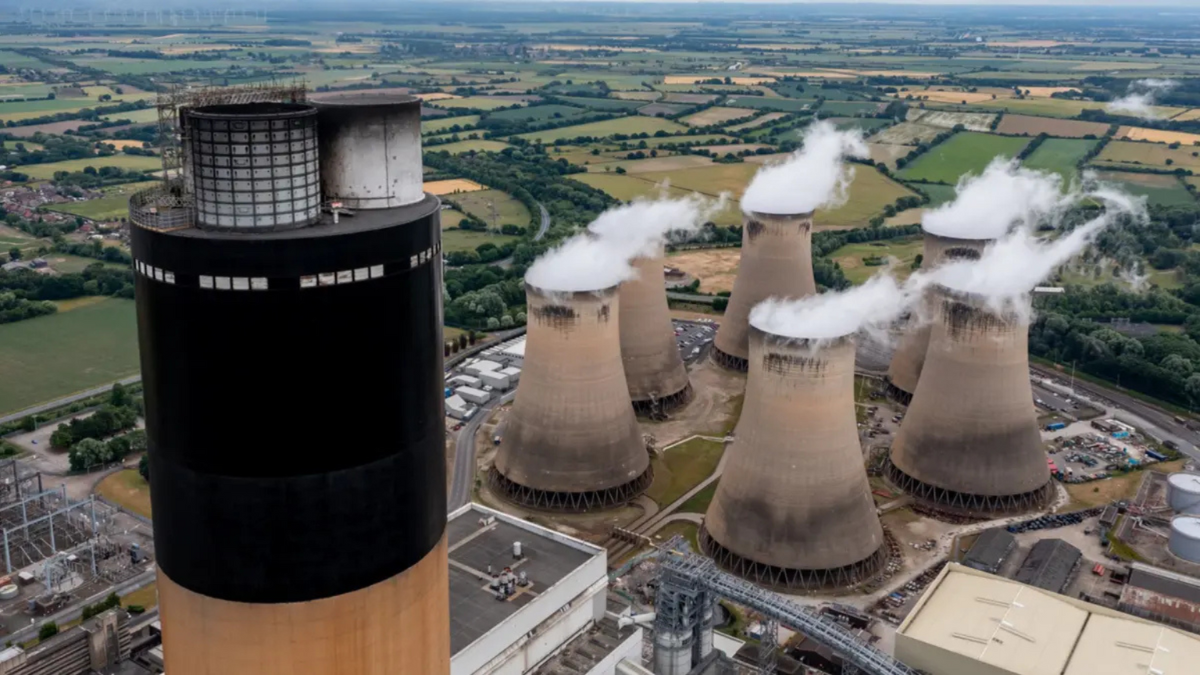 Large power station with cooling towers emitting steam