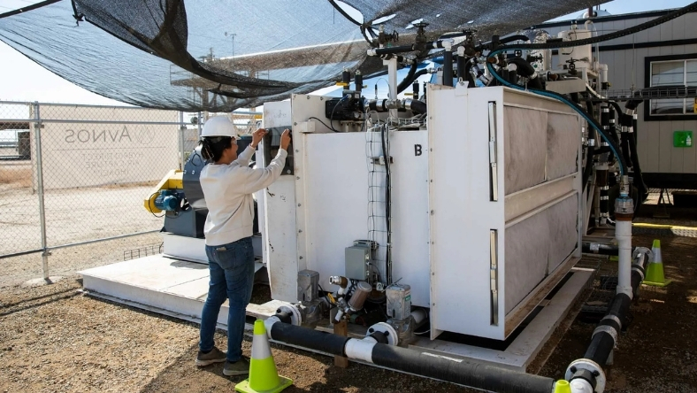 Technician inspecting direct air capture unit at carbon removal facility
